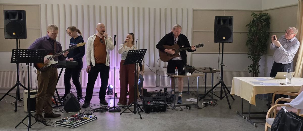 Full band setup with professional PA speakers at a live indoor event