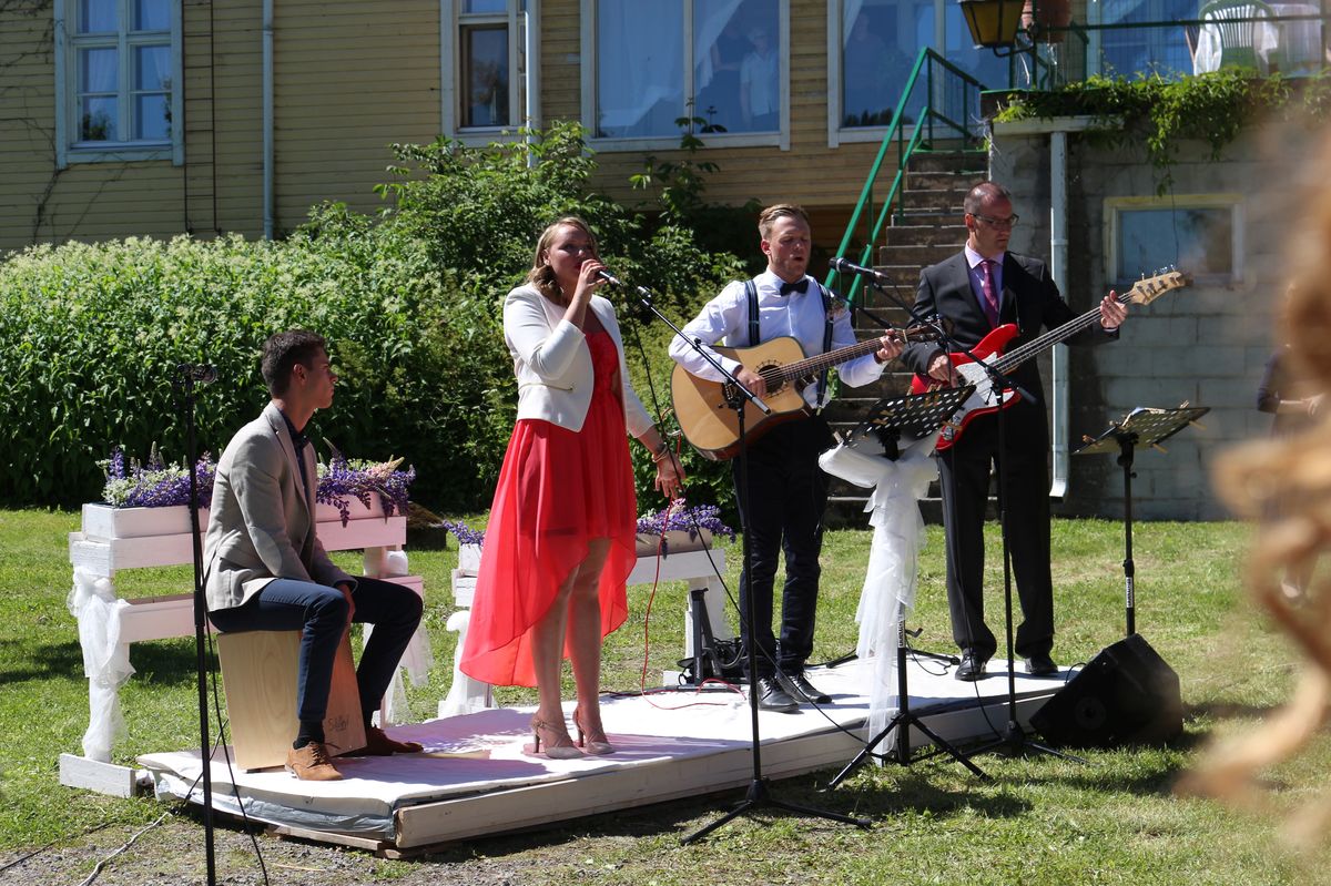 Live band performing at an outdoor summer wedding with professional PA system