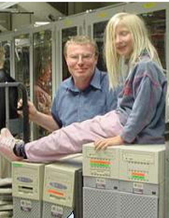 A young girl sitting on a decommissioned server box in a data centre, 2004